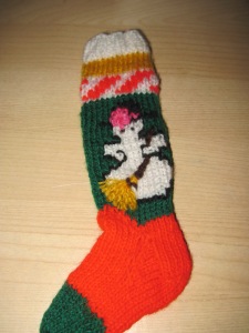 Doll-sized Christmas stocking with a snowman holding a broom